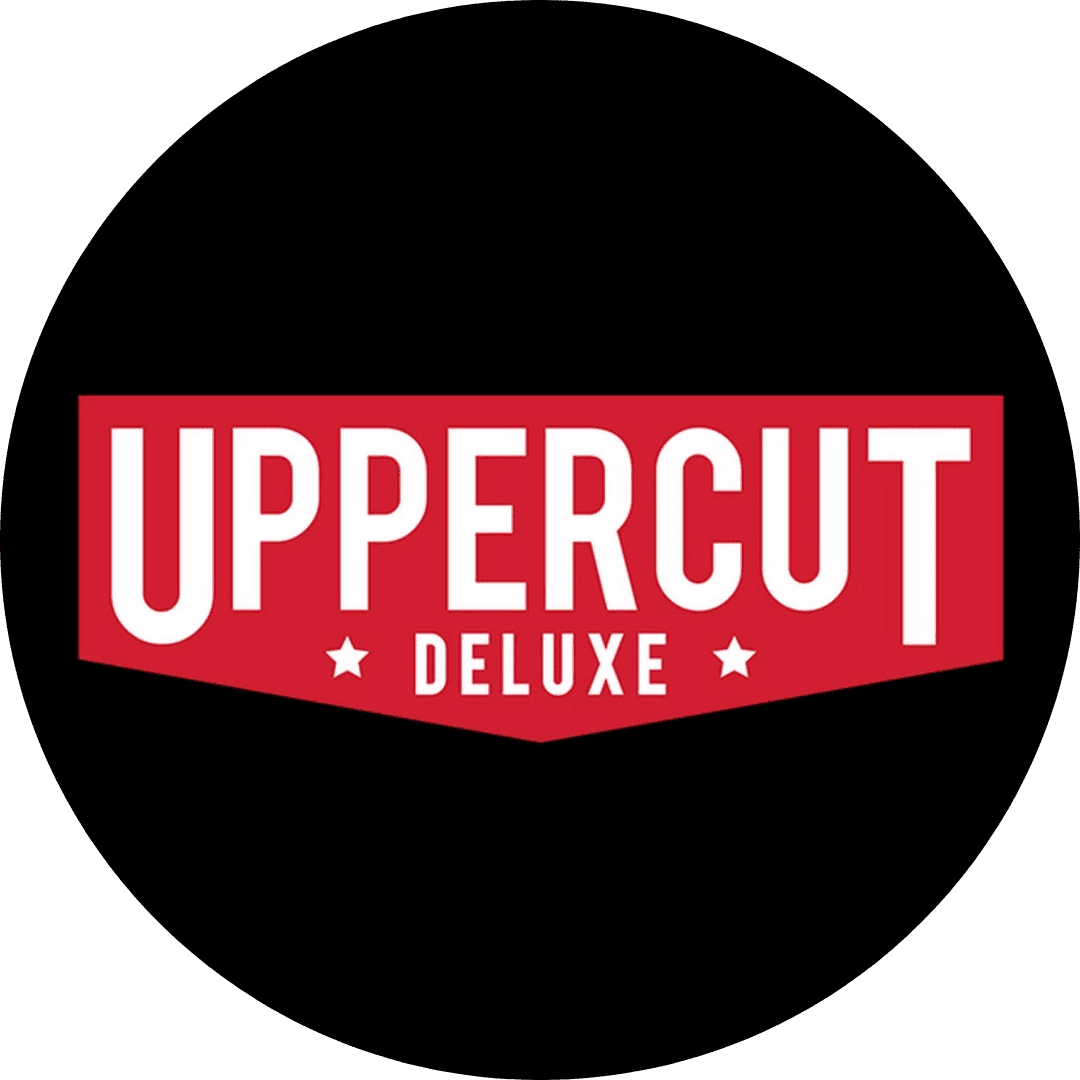 Uppercut Deluxe logo on a black circular background with bold red and white text.